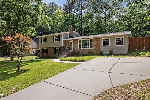 split level home featuring brick siding and a chimney