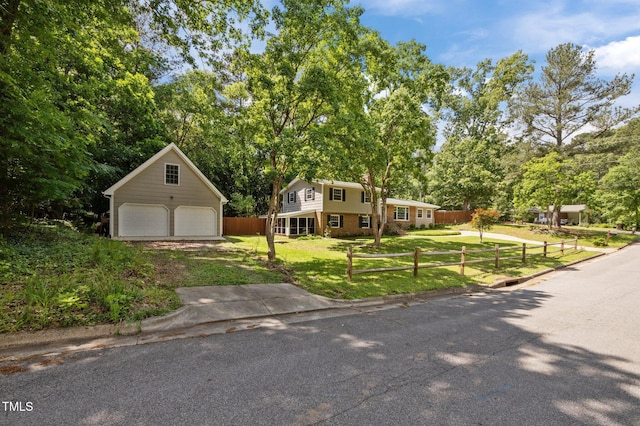 view of front of home with a detached garage, an outdoor structure, view of scattered trees, and brick siding