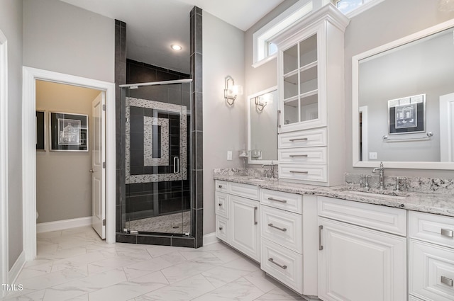 full bathroom with marble look tiles, a stall shower, and baseboards