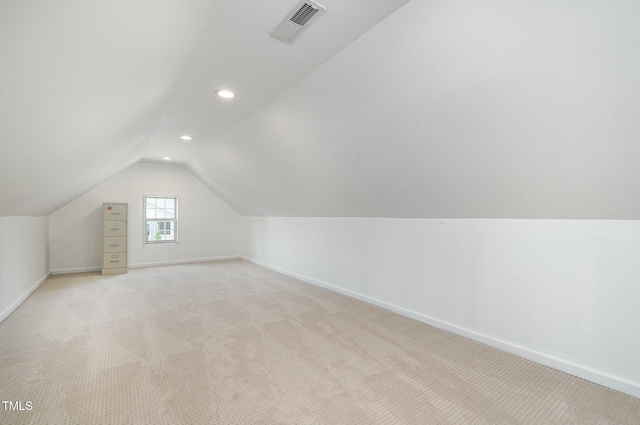 additional living space with vaulted ceiling, recessed lighting, baseboards, and light colored carpet