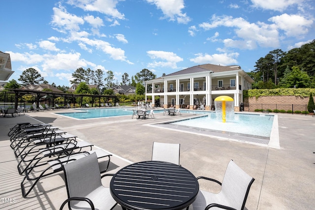 community pool featuring fence and a patio area