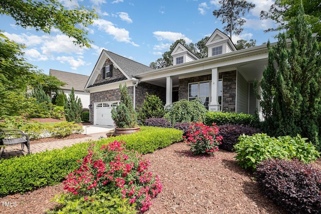 craftsman house with stone siding and a porch