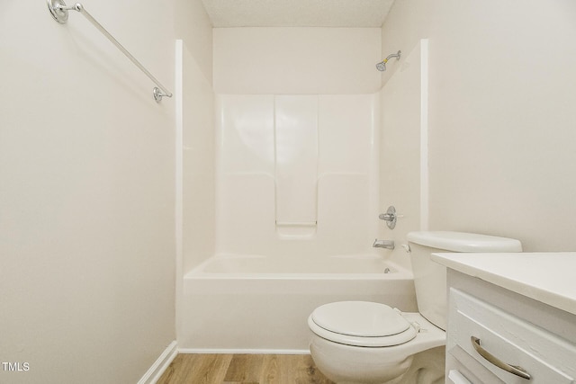 full bath featuring wood finished floors, toilet, vanity, and shower / bath combination