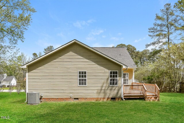 back of property with crawl space, central AC unit, a wooden deck, and a lawn
