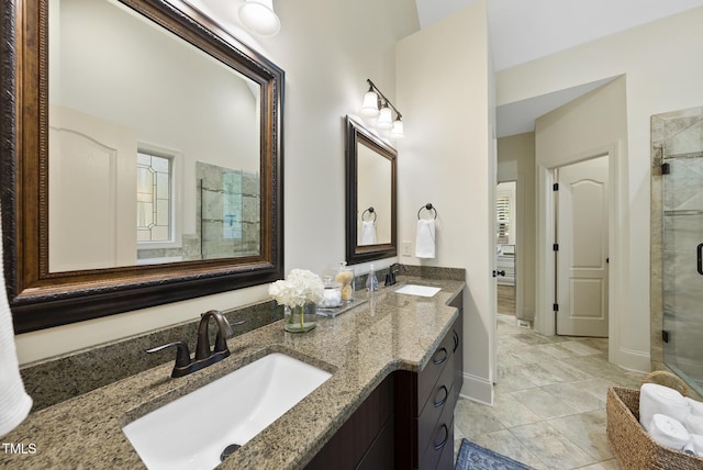1211 New Grissom Way, Wake Forest, NC 27587 - bathroom featuring a shower stall, double vanity, and baseboards