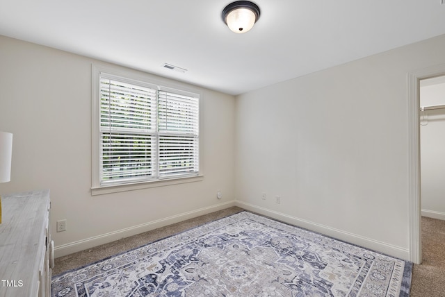 1211 New Grissom Way, Wake Forest, NC 27587 - unfurnished bedroom featuring carpet, a spacious closet, baseboards, and a closet