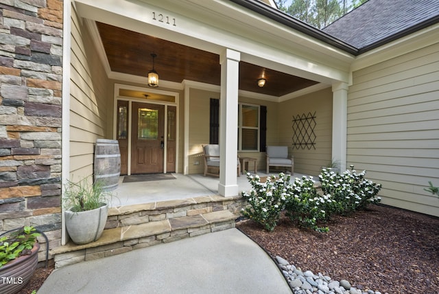 1211 New Grissom Way, Wake Forest, NC 27587 - property entrance featuring covered porch, a shingled roof, and stone siding