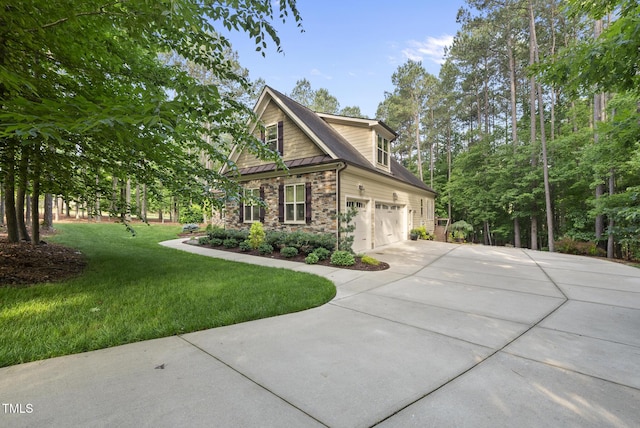 1211 New Grissom Way, Wake Forest, NC 27587 - view of home's exterior featuring driveway, stone siding, an attached garage, a yard, and a standing seam roof
