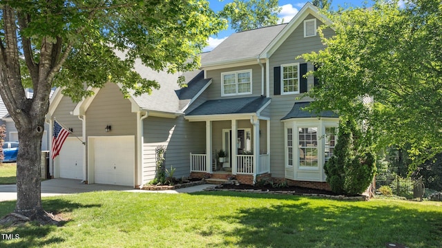 view of front of property featuring a front lawn, driveway, roof with shingles, a porch, and a garage