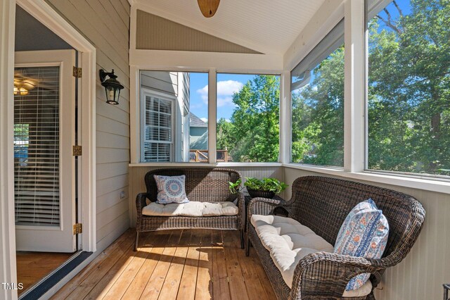 sunroom / solarium with lofted ceiling and ceiling fan