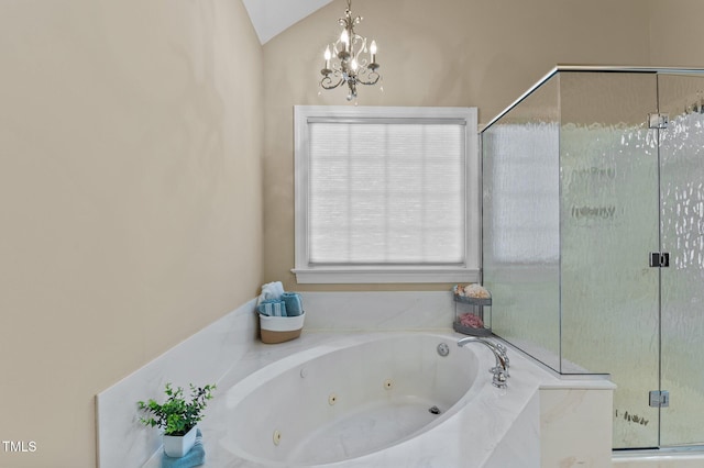 bathroom featuring a stall shower, a jetted tub, a chandelier, and vaulted ceiling