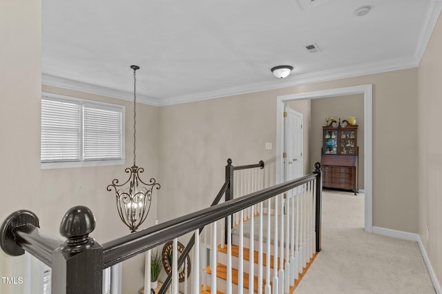 hall with an upstairs landing, a chandelier, light carpet, crown molding, and baseboards