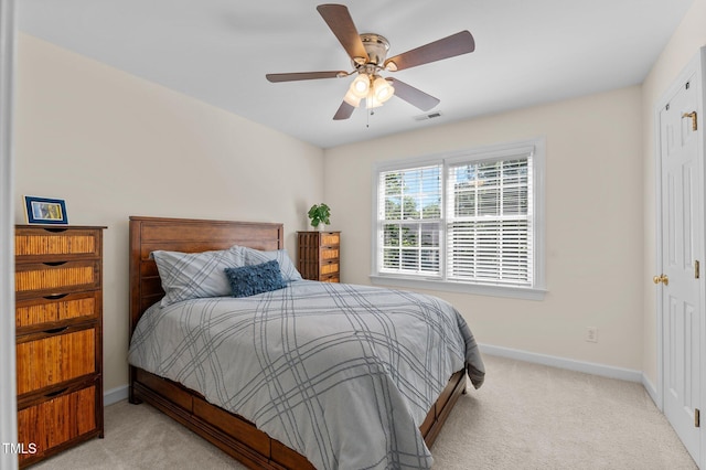 carpeted bedroom featuring baseboards and a ceiling fan