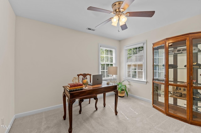office area featuring baseboards, light colored carpet, and ceiling fan
