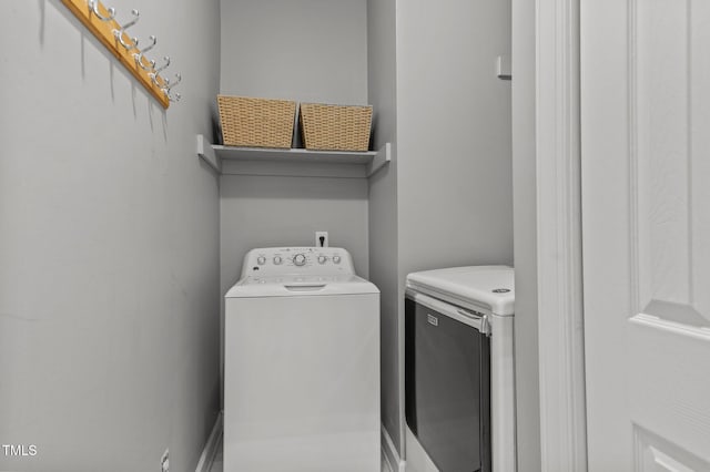 clothes washing area featuring washing machine and clothes dryer