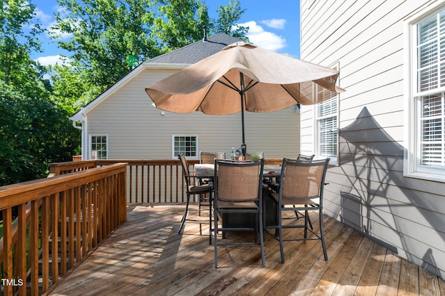 wooden terrace featuring outdoor dining area
