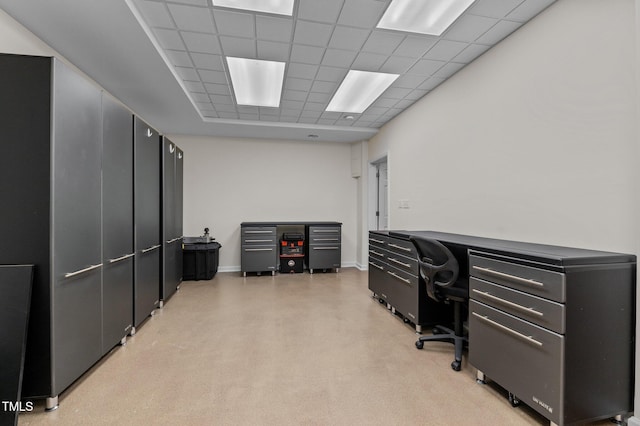 office featuring a paneled ceiling and finished concrete flooring