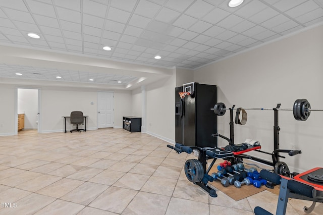 exercise room featuring recessed lighting, light tile patterned flooring, and baseboards