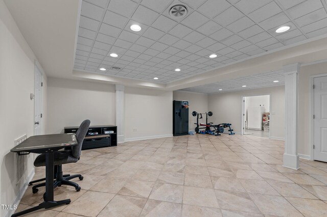 office space featuring a raised ceiling, recessed lighting, baseboards, and light tile patterned floors