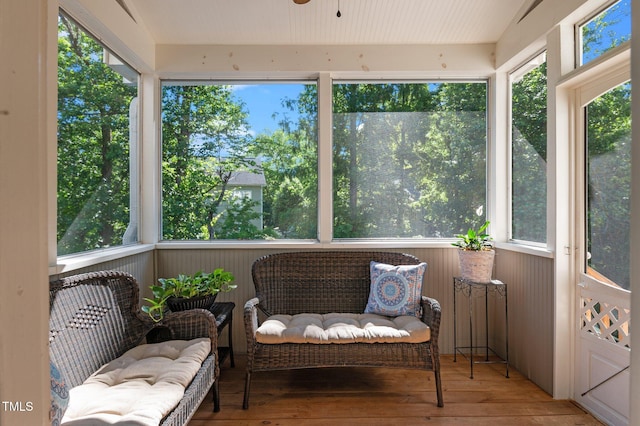 sunroom featuring healthy amount of natural light and a ceiling fan