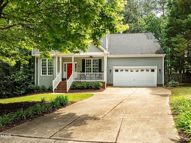 view of property hidden behind natural elements featuring a porch, a garage, driveway, fence, and a shingled roof