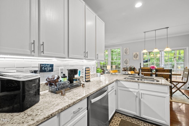 kitchen with stainless steel dishwasher, a sink, a peninsula, ornamental molding, and white cabinets