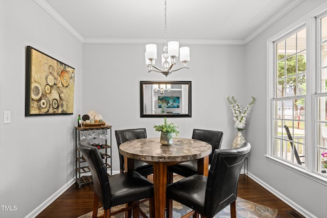 dining room with a chandelier, dark wood-type flooring, baseboards, and crown molding