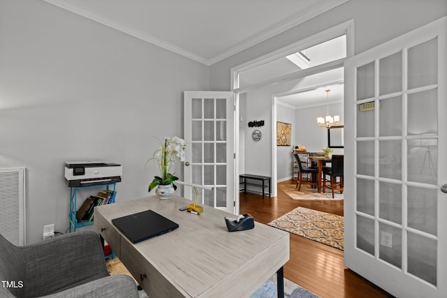 office space with a chandelier, ornamental molding, and hardwood / wood-style flooring