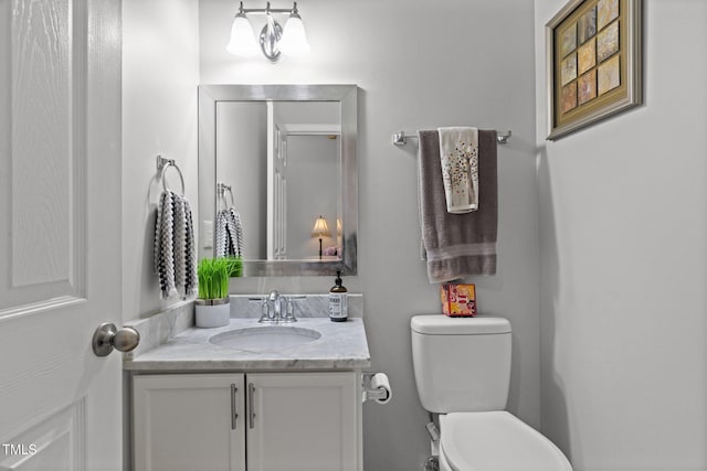 half bathroom with vanity and toilet