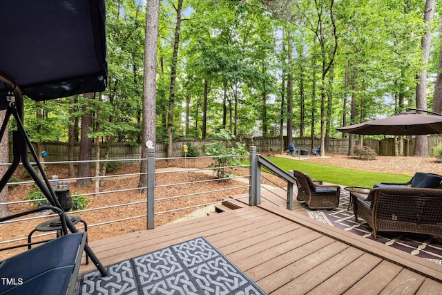 wooden deck featuring a fenced backyard and view of scattered trees
