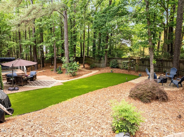 view of yard featuring a fire pit and a wooden deck