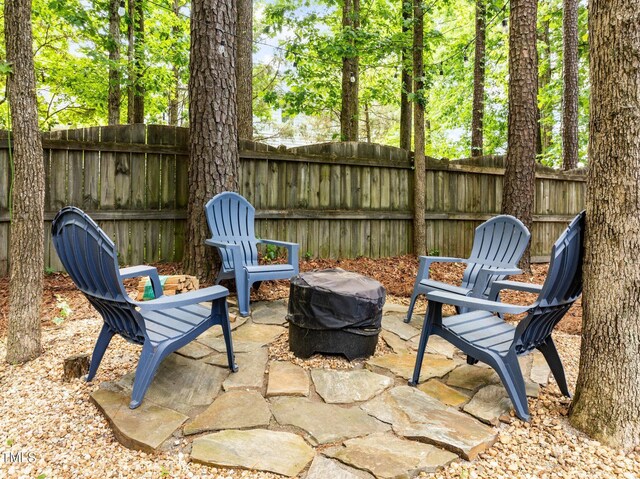 1204 Benoit Pl, Apex, NC 27502 - view of patio / terrace with a fenced backyard and a fire pit