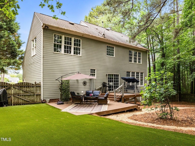rear view of property featuring a deck, a patio area, an outdoor hangout area, and a gate