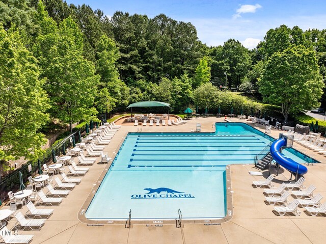1204 Benoit Pl, Apex, NC 27502 - community pool featuring a water slide, a patio, and fence