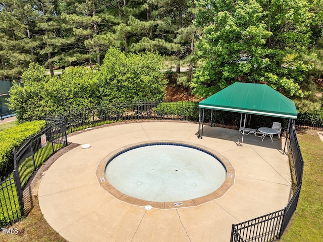 view of swimming pool featuring fence and a gazebo