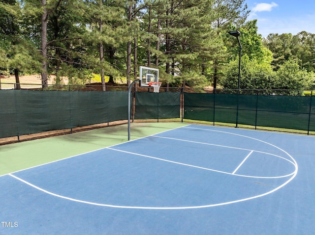 view of basketball court with community basketball court and fence
