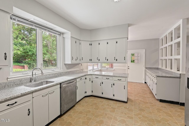 kitchen with dishwasher, a sink, white cabinets, and light stone countertops