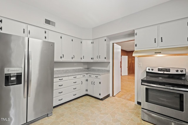 kitchen with appliances with stainless steel finishes, under cabinet range hood, light countertops, and white cabinetry