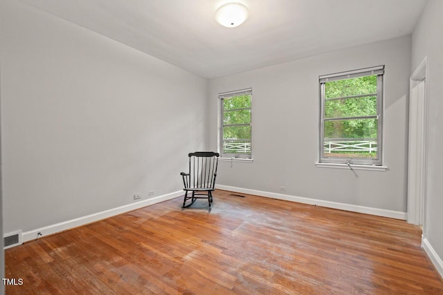 unfurnished room with wood finished floors and baseboards