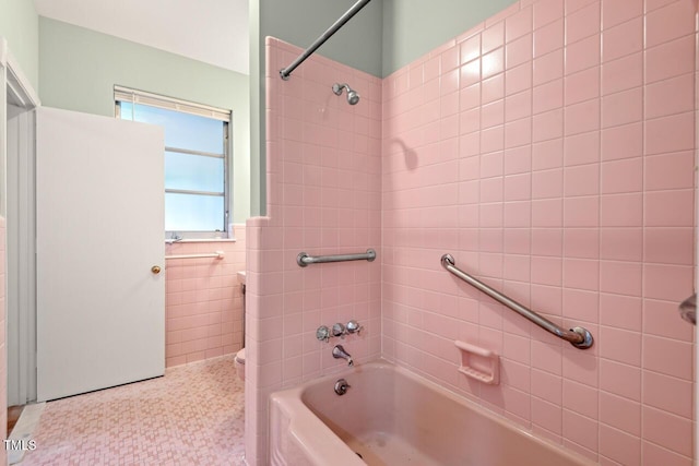 bathroom featuring shower / bathtub combination and tile walls