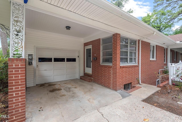 view of front facade featuring brick siding, concrete driveway, entry steps, and a carport