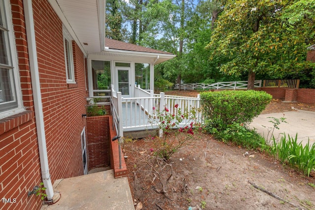 view of yard with a sunroom and fence
