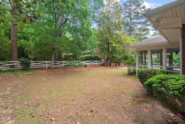 fenced backyard featuring a sunroom