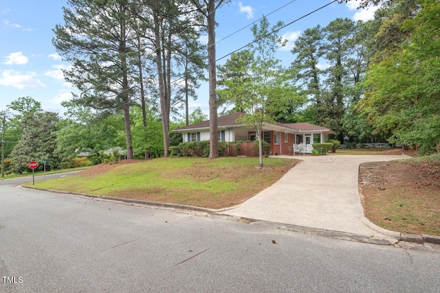 view of front facade featuring driveway and a front yard