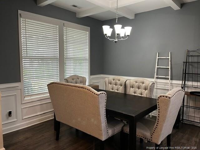 116 Georgia Dr, Raeford, NC 28376 - dining area featuring beam ceiling, wood finished floors, a chandelier, a wainscoted wall, and a decorative wall