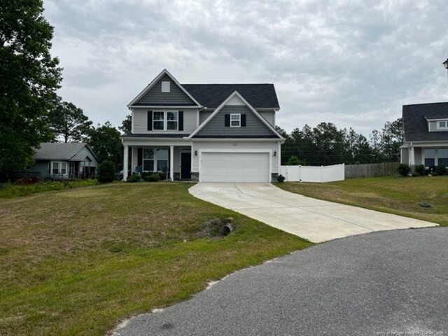 116 Georgia Dr, Raeford, NC 28376 - view of front of home with driveway, a garage, and a porch