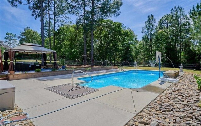 outdoor pool featuring a patio and a gazebo