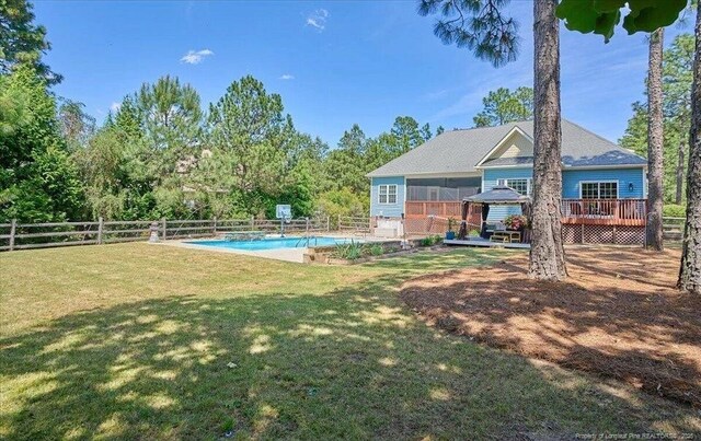 view of yard with a wooden deck and a sunroom