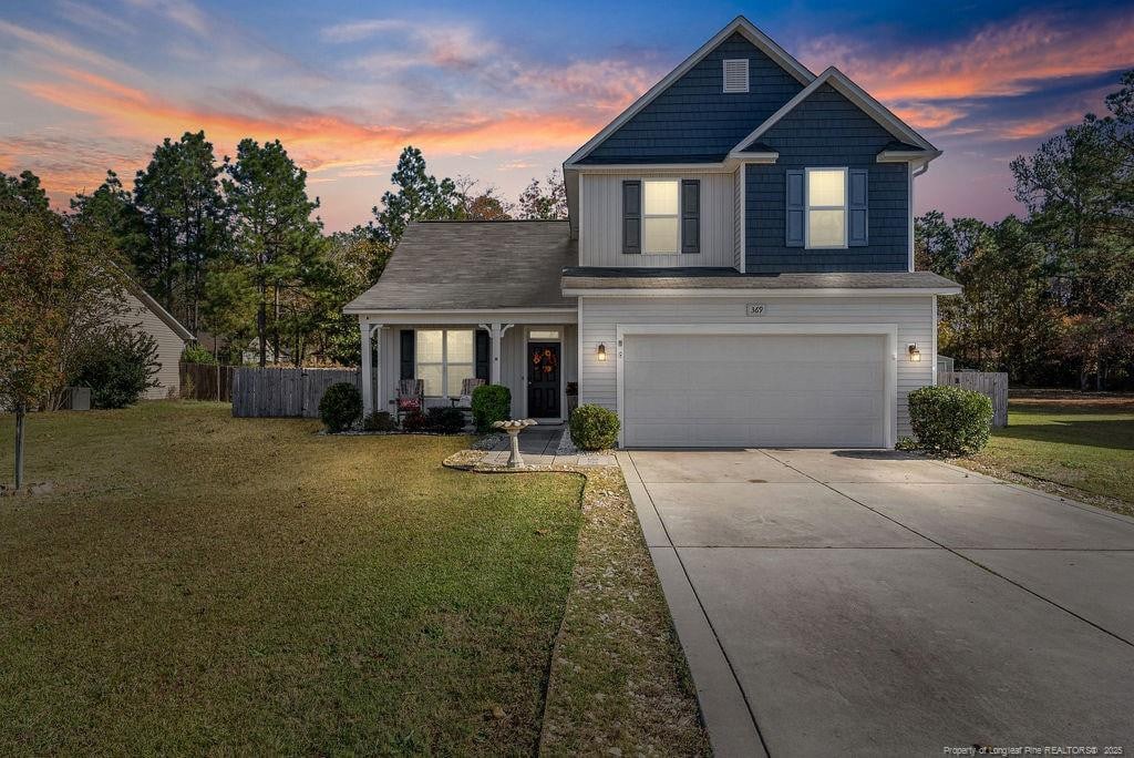 369 Shepherd Trl, Aberdeen, NC 28315 - traditional home with a garage, concrete driveway, and board and batten siding