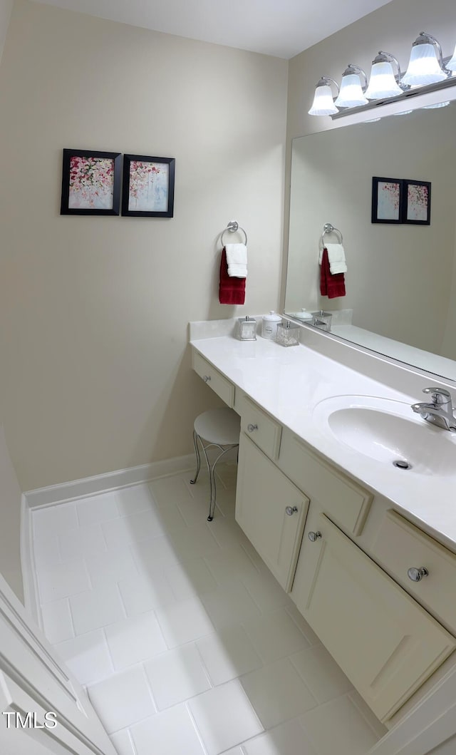 bathroom featuring vanity, tile patterned floors, and baseboards